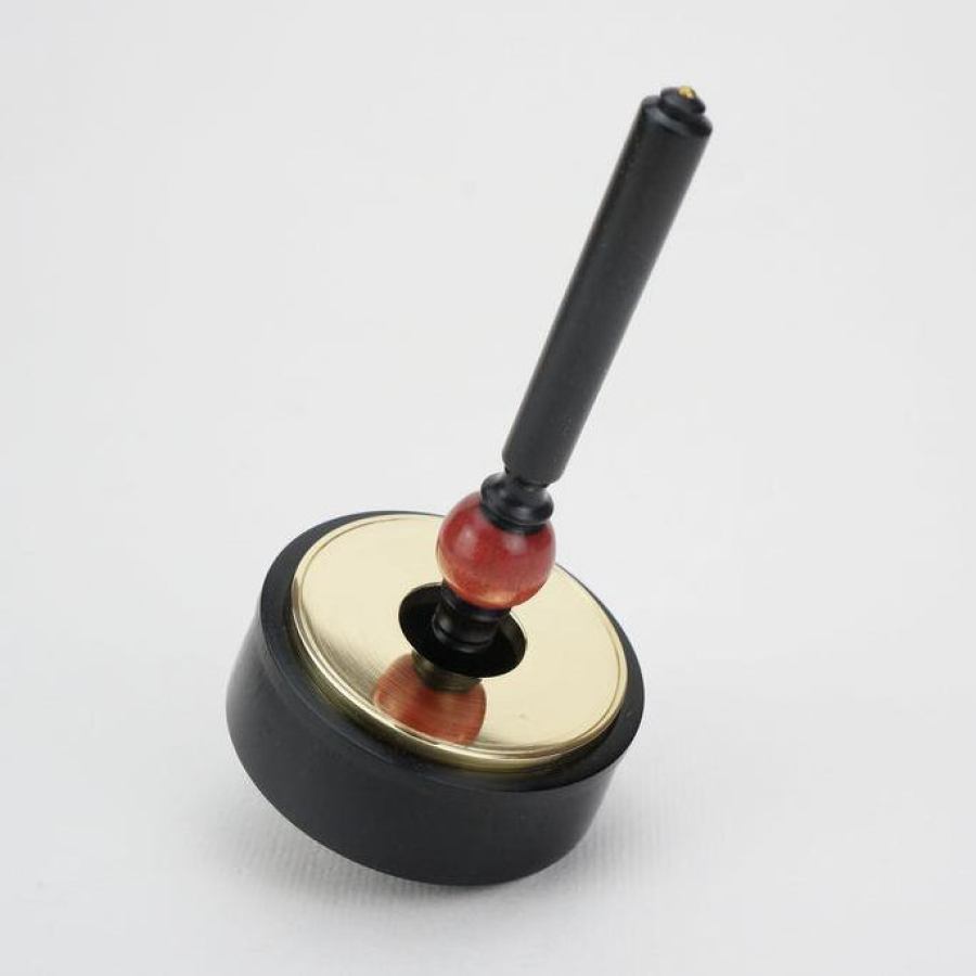 Collector's item: Artful Ebony Spinning Top with Brass Inlay